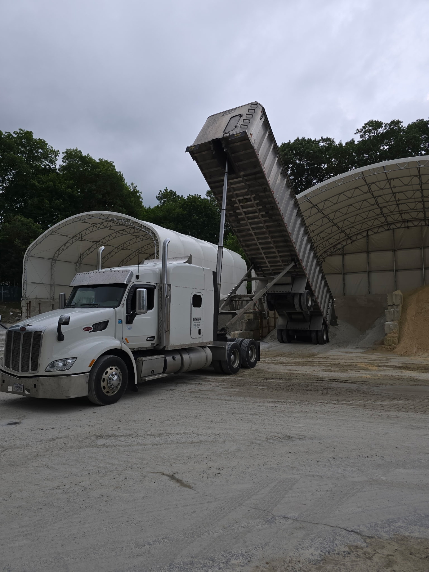 Truck unloading materials at construction site