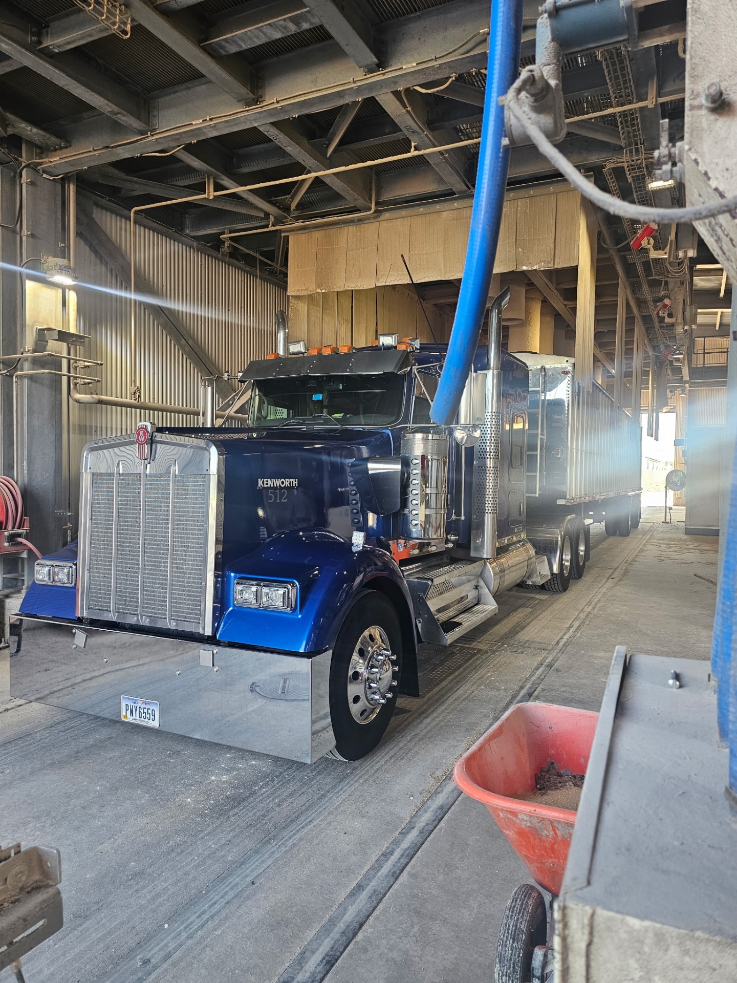 Blue semi-truck parked in industrial garage