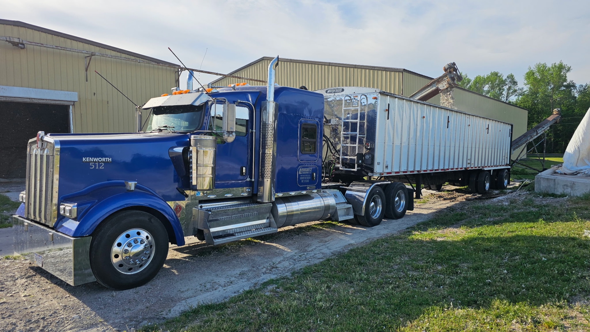Blue Kenworth truck parked near building.