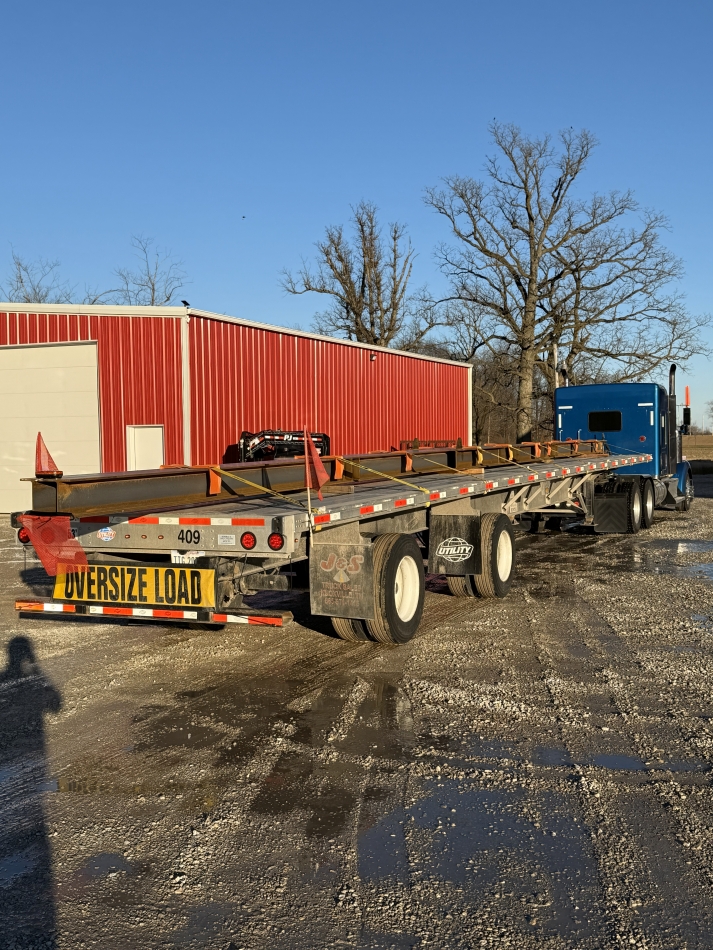Oversize load trailer at red garage