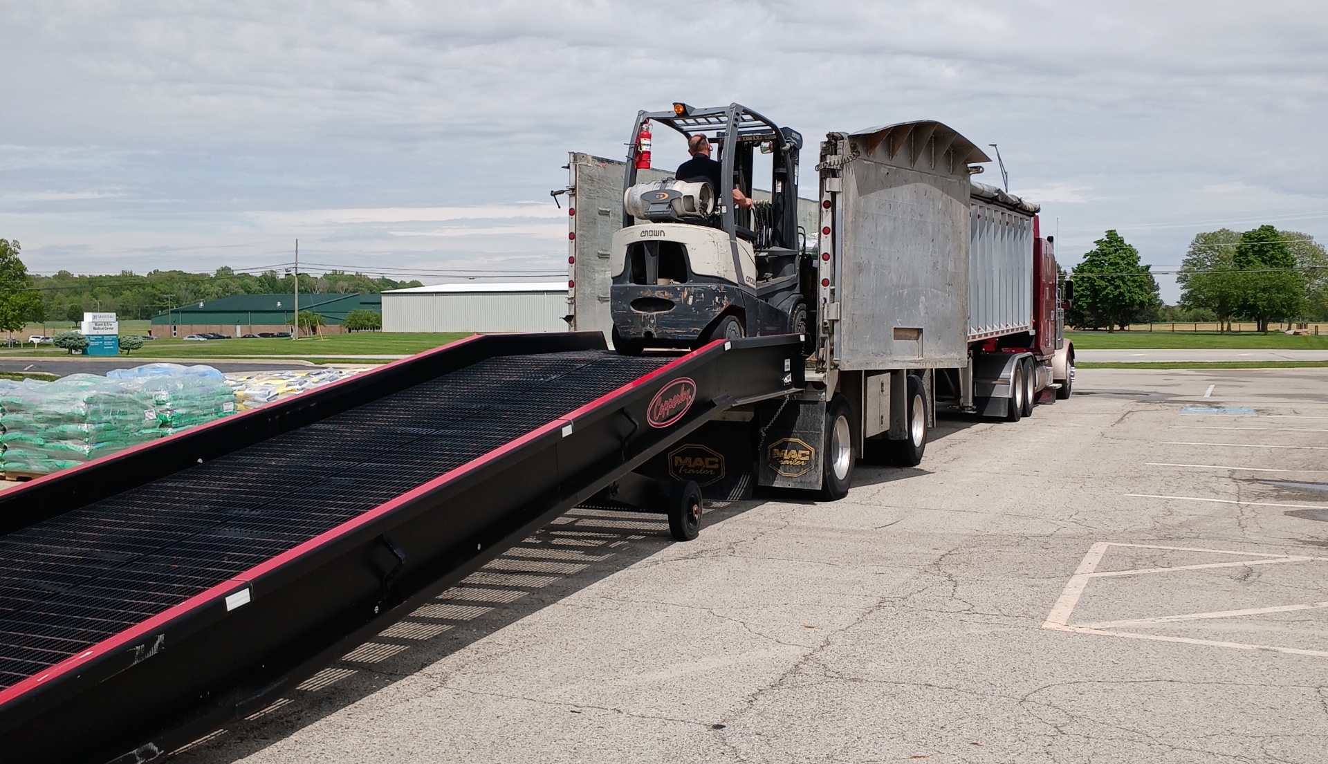 Loading truck with forklift and ramp outdoors