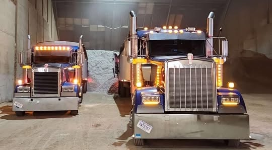 Two trucks parked in a warehouse